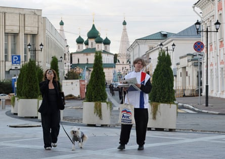 A campaign worker handing out promotional materials for United Russia in Yaroslavl.