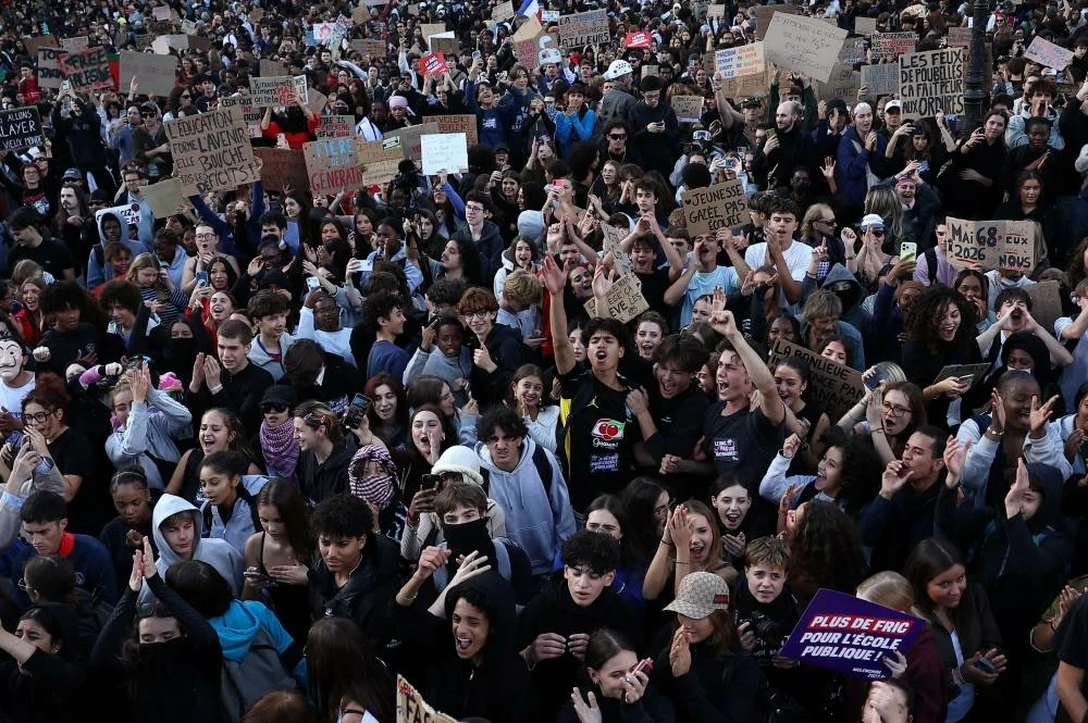 Protesters take part in a demonstration by French high school and university students in Paris as part of a nationwide day of protests and blockades supported by teachers and school parents to demand better school conditions in France, October 8, 2026. REUTERS