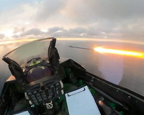 Viewed from an F-16 cockpit, a fiery missile streak shoots across the sky above the Black Sea